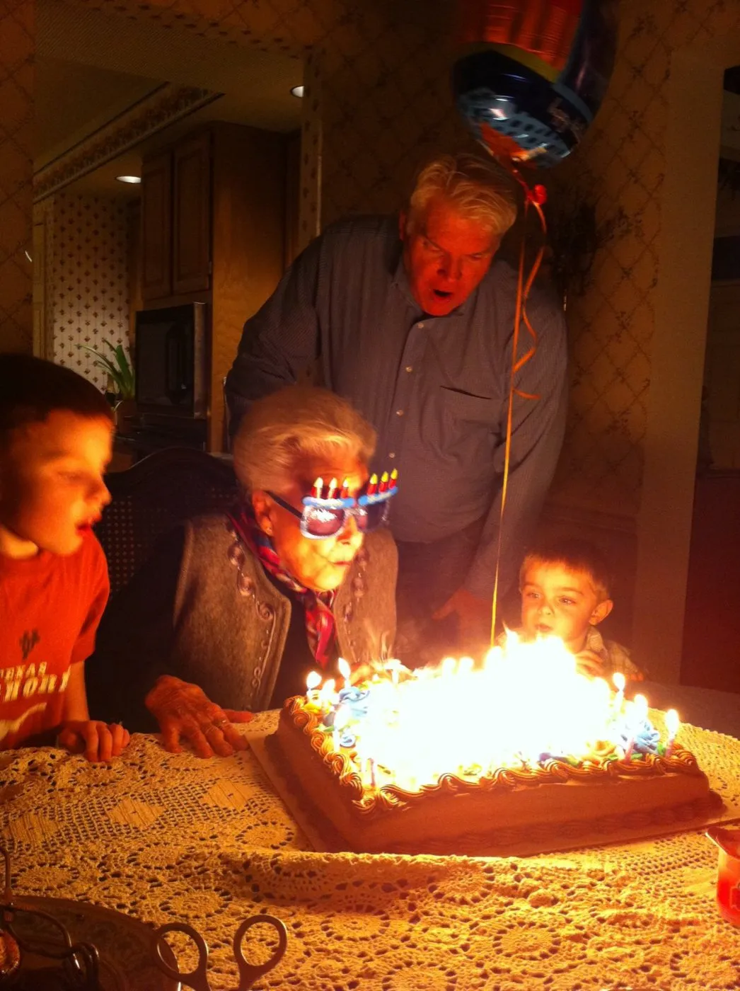 Grandma Eileen blowing out birthday candles