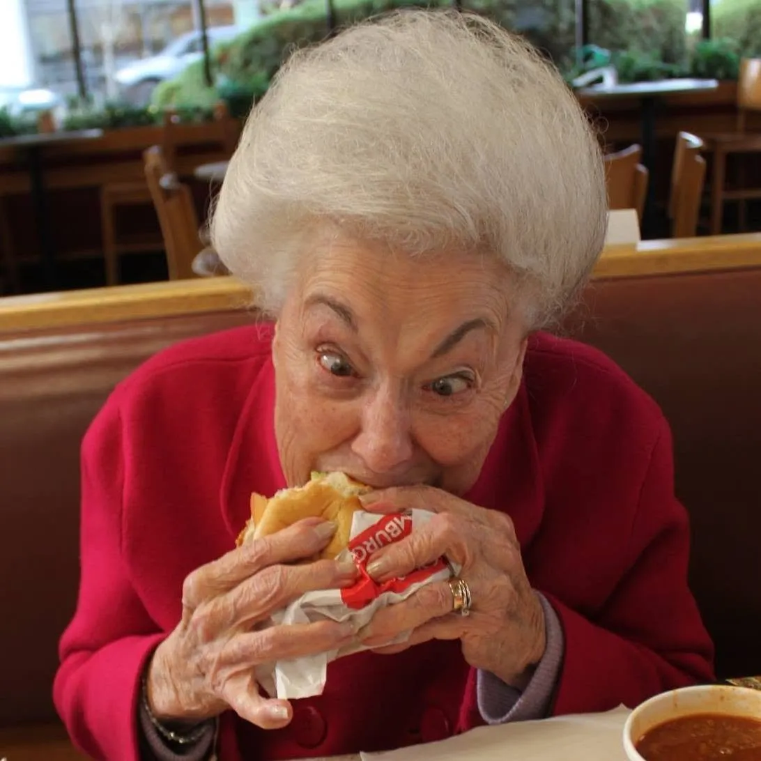 Grandma Eileen biting into a burger