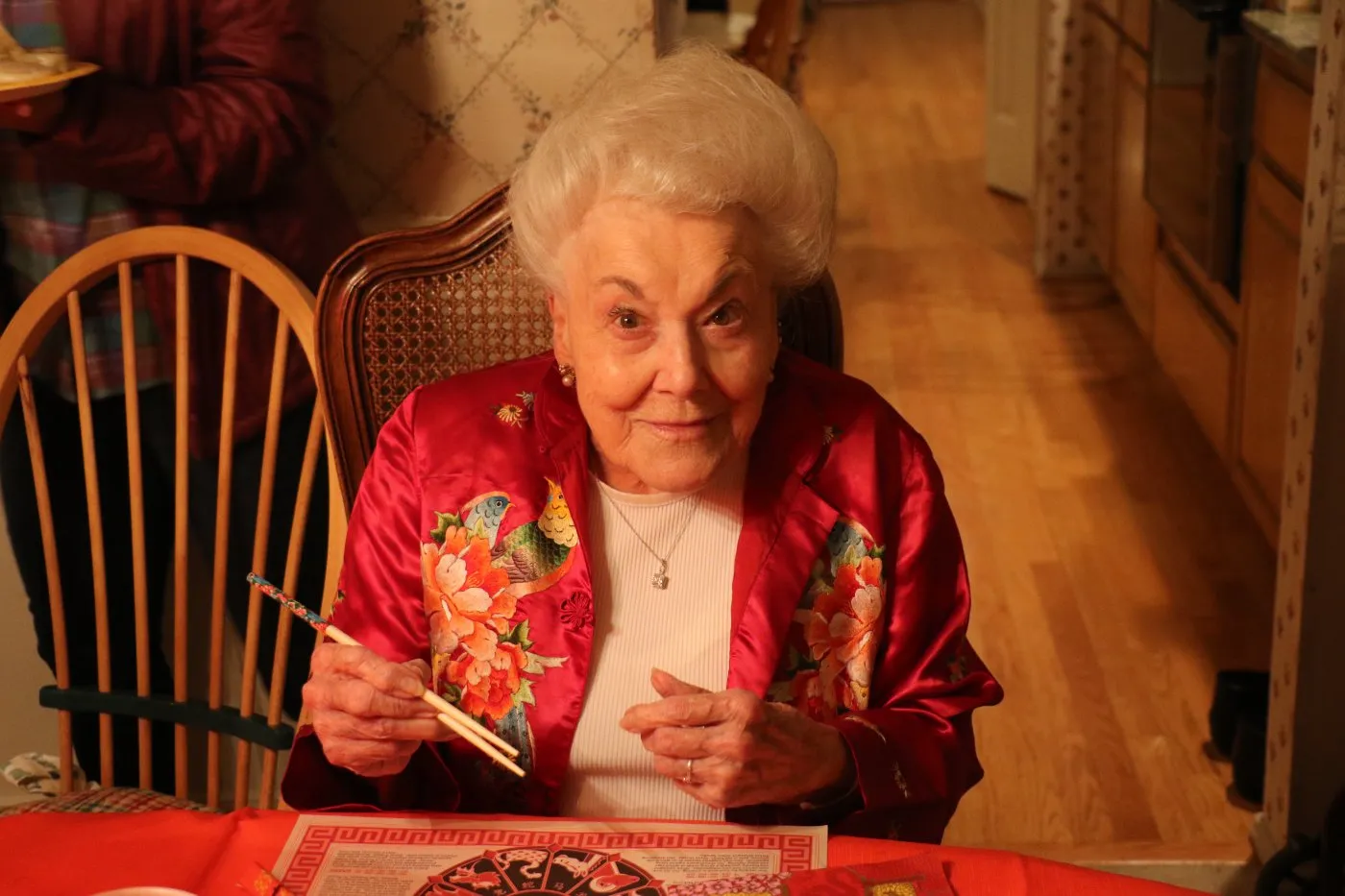 Grandma Eileen with chopsticks at dinner