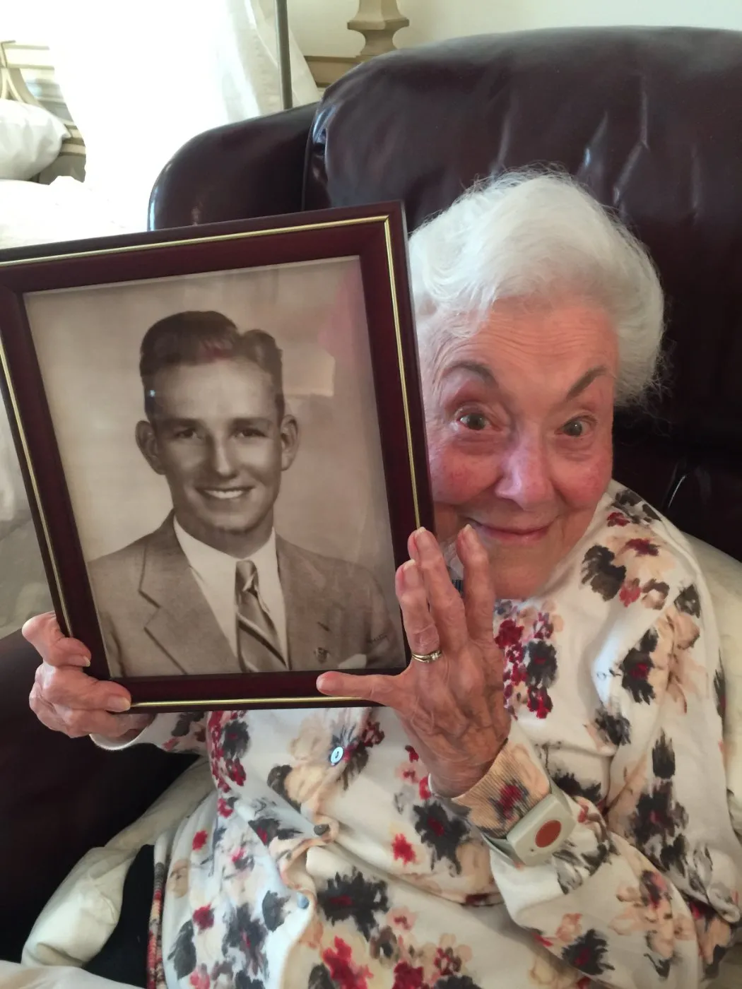 Grandma Eileen holding a framed portrait
