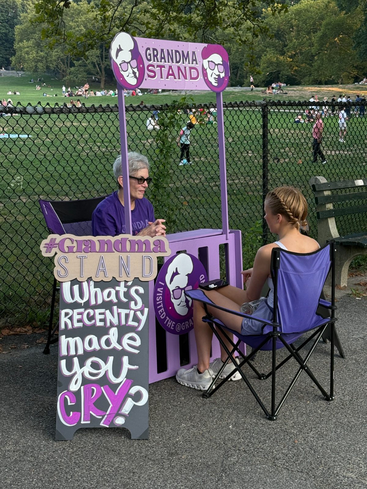 A grandma chats with a young woman at the stand in Central Park
